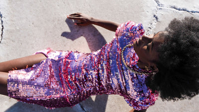 Studio 504 female model wearing a pink sequin short cocktail dress.